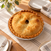 Whole Brown’s Market Crispy Apple Pie in its foil pan on a dining table set for a gathering