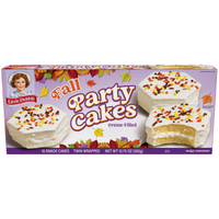 Front view of Little Debbie Vanilla Fall Party Cakes with white icing and colorful autumn sprinkles