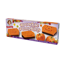 Left-angle view of a Little Debbie Brownie Pumpkins box with orange-iced chocolate brownies and carved pumpkin faces.