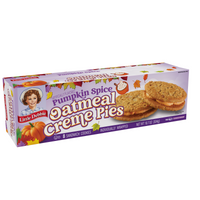 Right-angle view of Little Debbie Pumpkin Spice Oatmeal Creme Pies with soft oatmeal cookies and pumpkin spice creme.