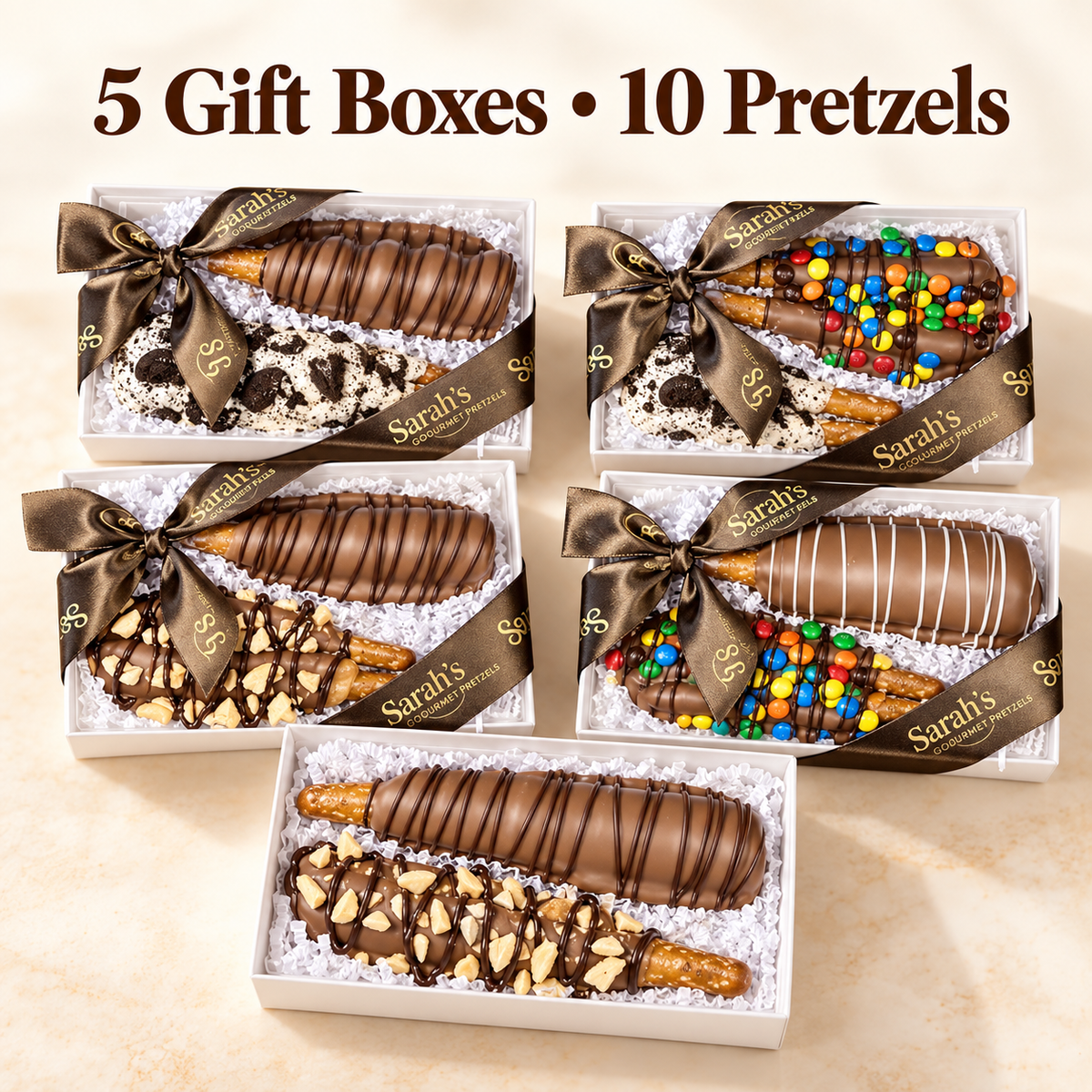 Five gift boxes of Sarah's Pretzels, each containing two chocolate-dipped pretzels decorated with drizzles, nuts, and colorful candies, arranged on a light beige background with the text '5 Gift Boxes • 10 Pretzels' at the top.