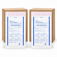 Two brown cardboard boxes with white plastic identification pouches featuring blue printed text and fields for card and dice pickup, shown on a clean white background.