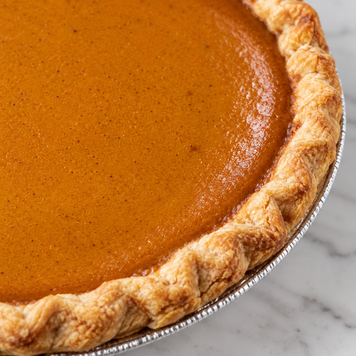 Close view of Brown’s Market Sweet Pumpkin Pie filling and crimped crust.
