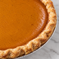 Close view of Brown’s Market Sweet Pumpkin Pie filling and crimped crust.