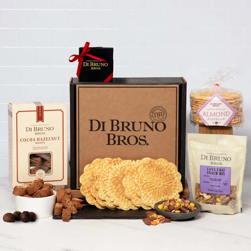 Di Bruno Bros. Dolce gift box displayed with truffles, biscotti, pizzelles and a packaged snack mix