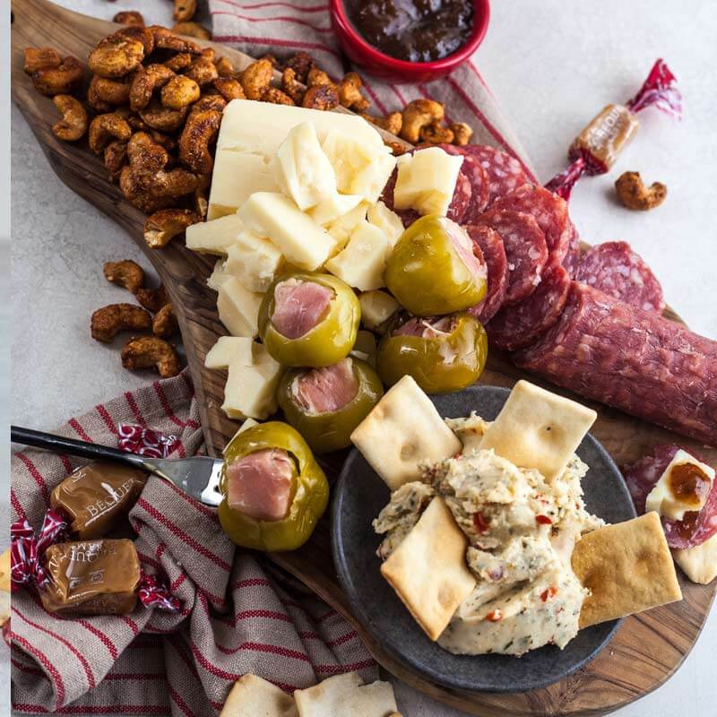 Assortment of cheese spreads, crackers, olives, nuts and savory snacks from the Di Bruno Bros. Happy Hour Kit