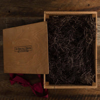 Open Di Bruno Bros. branded wooden display crate with packing material and lid