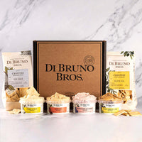 Di Bruno Bros. Cheese Spread Sampler gift box pictured with four example cheese spreads and two bags of crostini