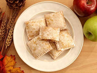 Drake's Apple Fruit Pies arranged on a plate with red and green apples