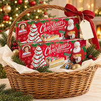 Two Little Debbie Vanilla Christmas Tree Cakes boxes arranged in a festive wicker gift basket with a blank gift tag.