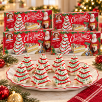 Four Little Debbie Vanilla Christmas Tree Cakes boxes displayed with decorated tree cakes on a holiday dessert platter.