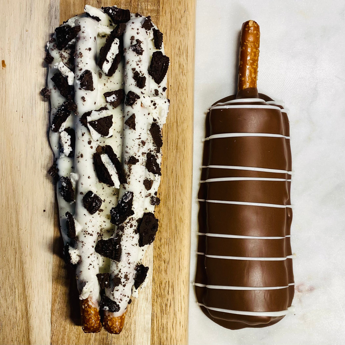Cookies-N-Cream and smooth milk chocolate gourmet pretzels with decorative drizzle