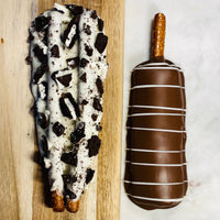 Cookies-N-Cream and smooth milk chocolate gourmet pretzels with decorative drizzle