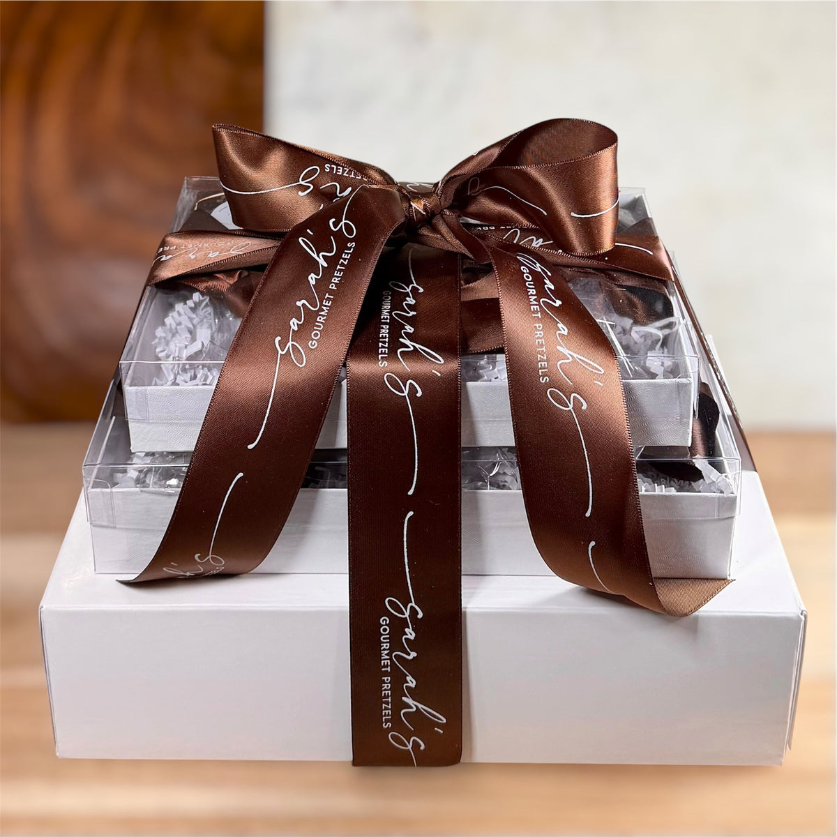 Sarah’s Gourmet Pretzels gluten-free snack gift tower in white boxes tied with a brown branded bow
