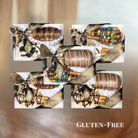 Five Sarah’s Gourmet Pretzels gluten-free gift boxes displaying 10 chocolate-covered pretzel rods in caramel, cookie, candy, peanut butter and cashew flavor pairings