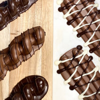 Close-up assortment of Sarah’s Gourmet milk, dark and drizzled chocolate-covered pretzels
