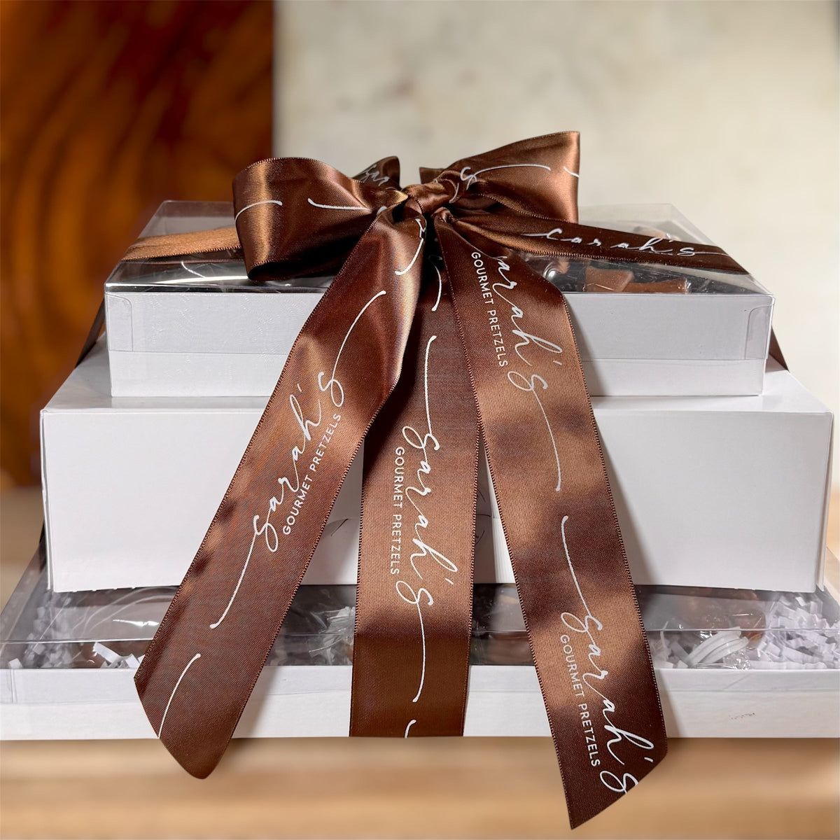 Sarah's Gourmet Gluten-Free Pretzel Tower in stacked white gift boxes with a brown branded ribbon