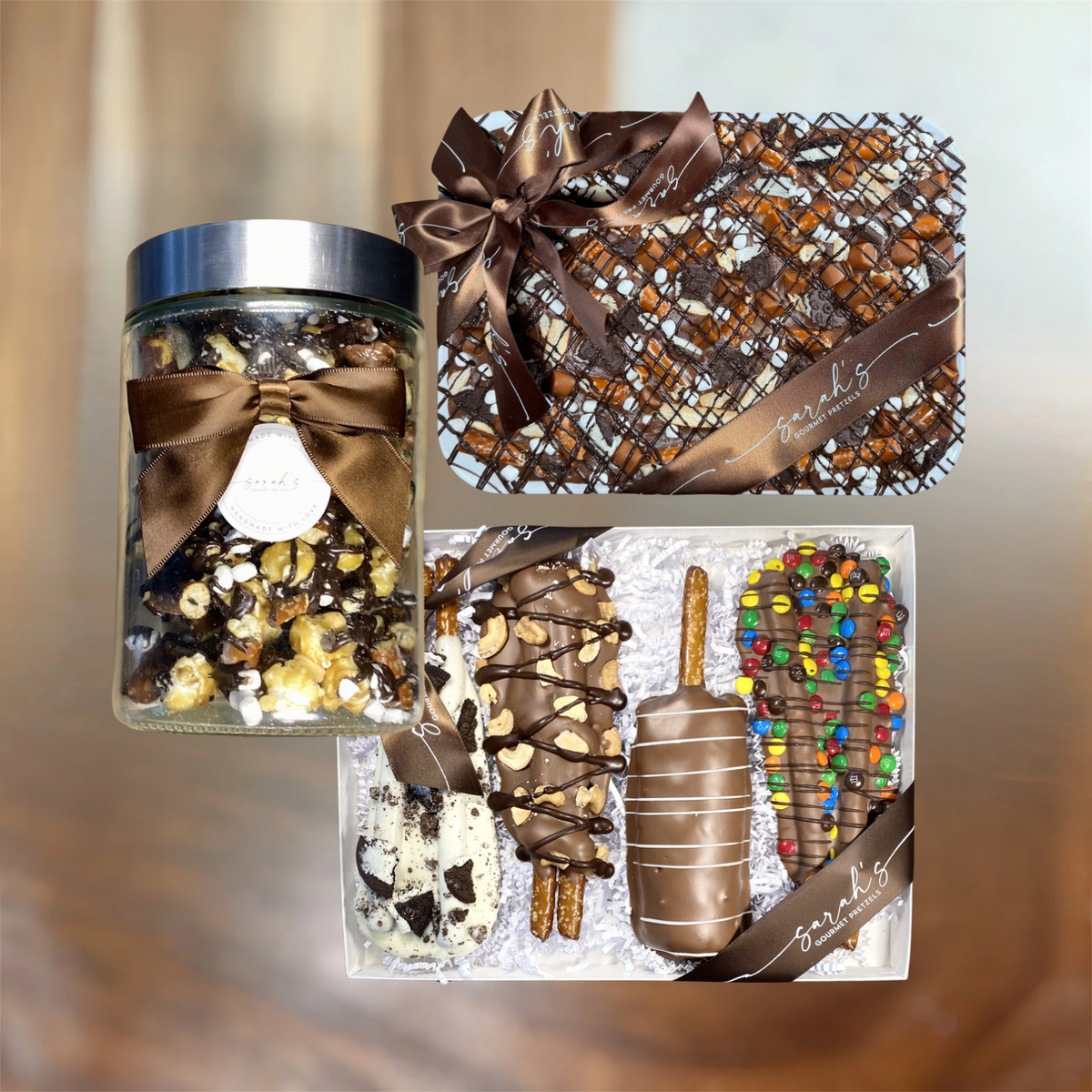 Sarah's Gourmet Party Pack with a popcorn jar, four chocolate pretzels and a ribbon-wrapped chocolate bark platter