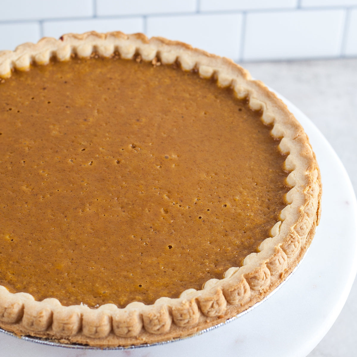 Close view of a smooth pie filling and crimped crust